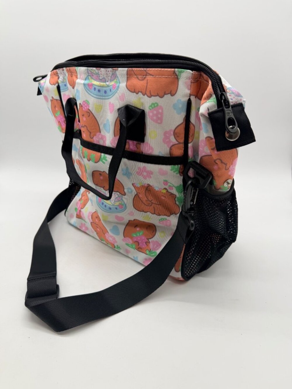 Feifeiyu brand backpack features a colorful cartoon capybara and strawberry prin